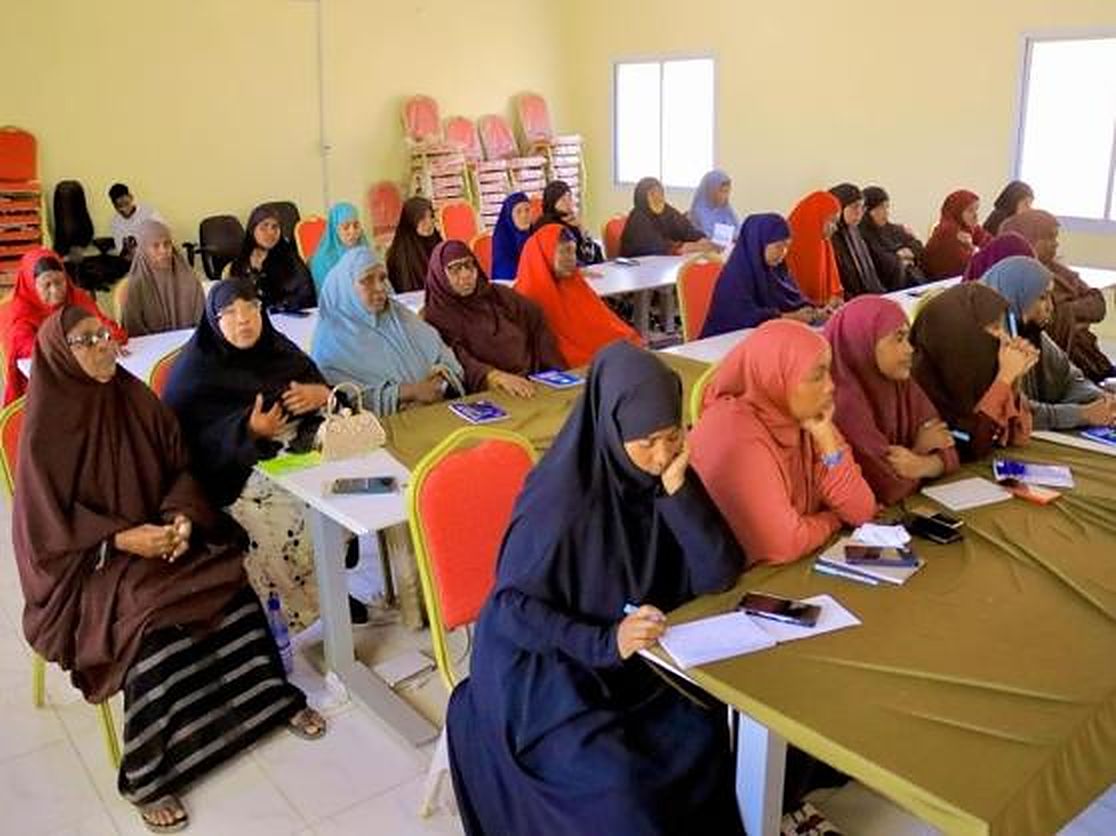 Women taking notes at a training session