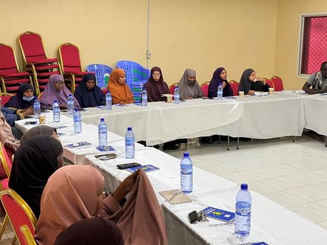 Women seated at conference tables
